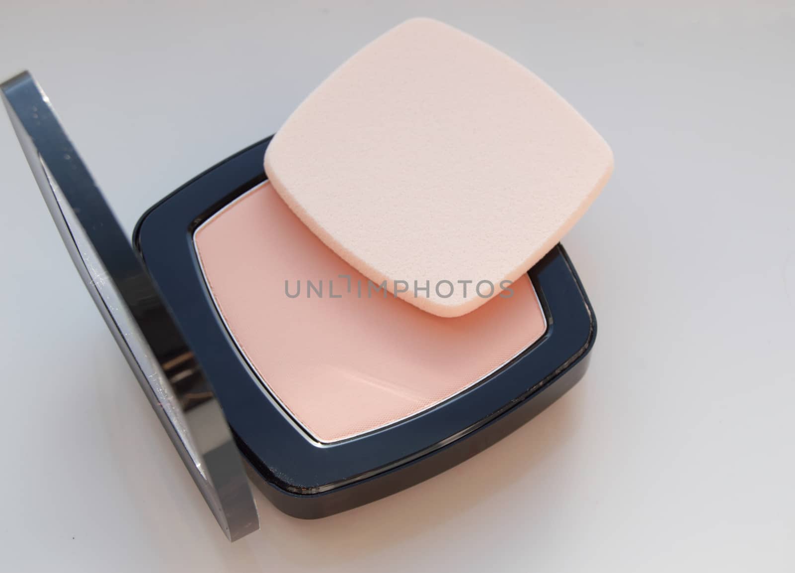 Compact powder with puff for makeup, on white background, top view by claire_lucia