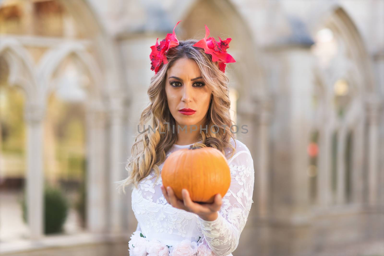 Portrait of fairy tale queen holding a pumpkin