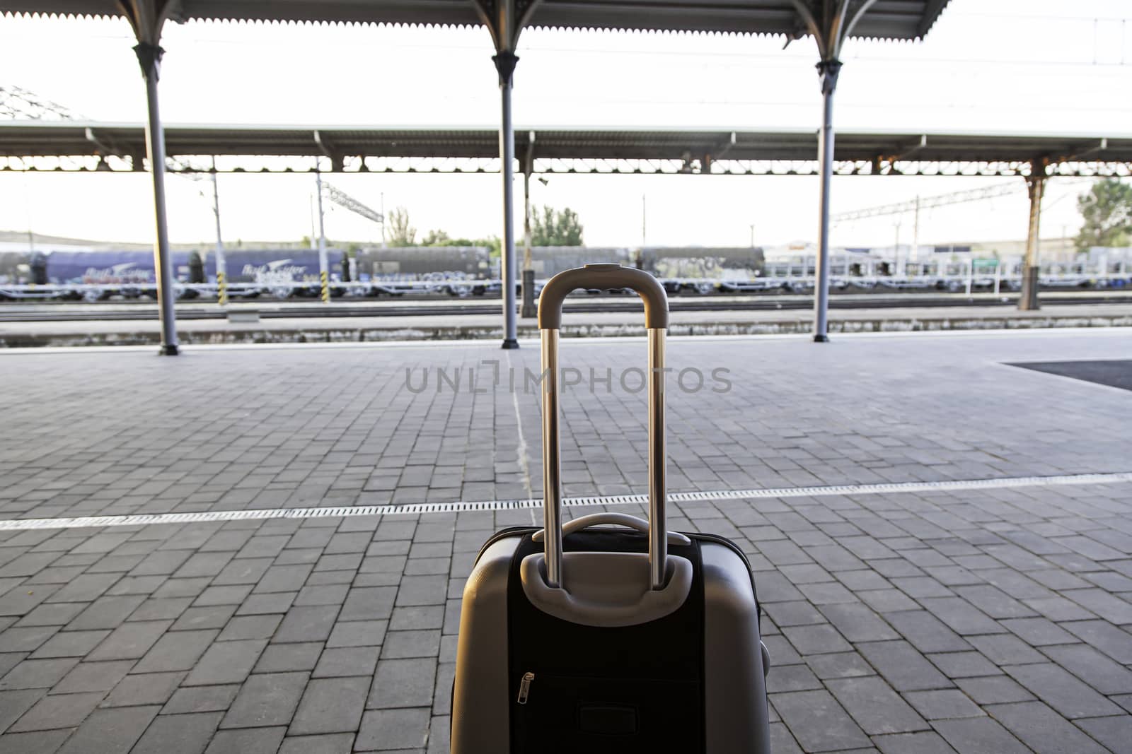 Suitcase in a train station, detail of a trip, vacation