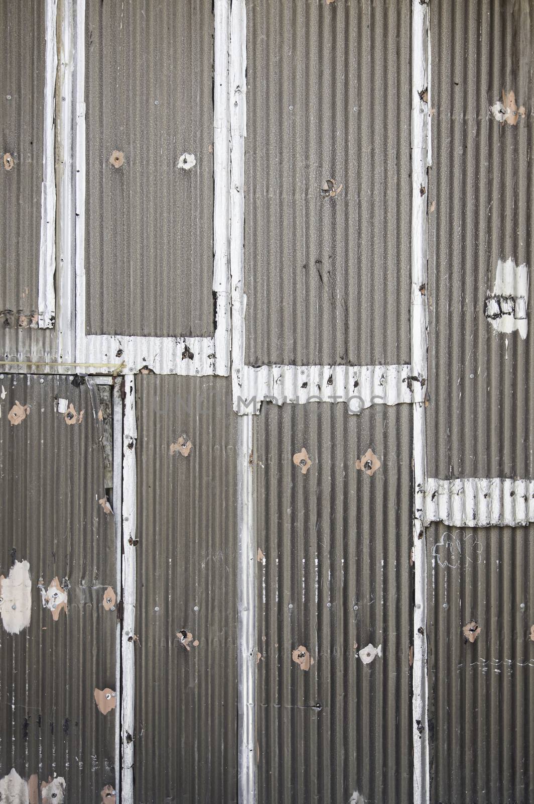 Old metal fence detail of a textured, rusty