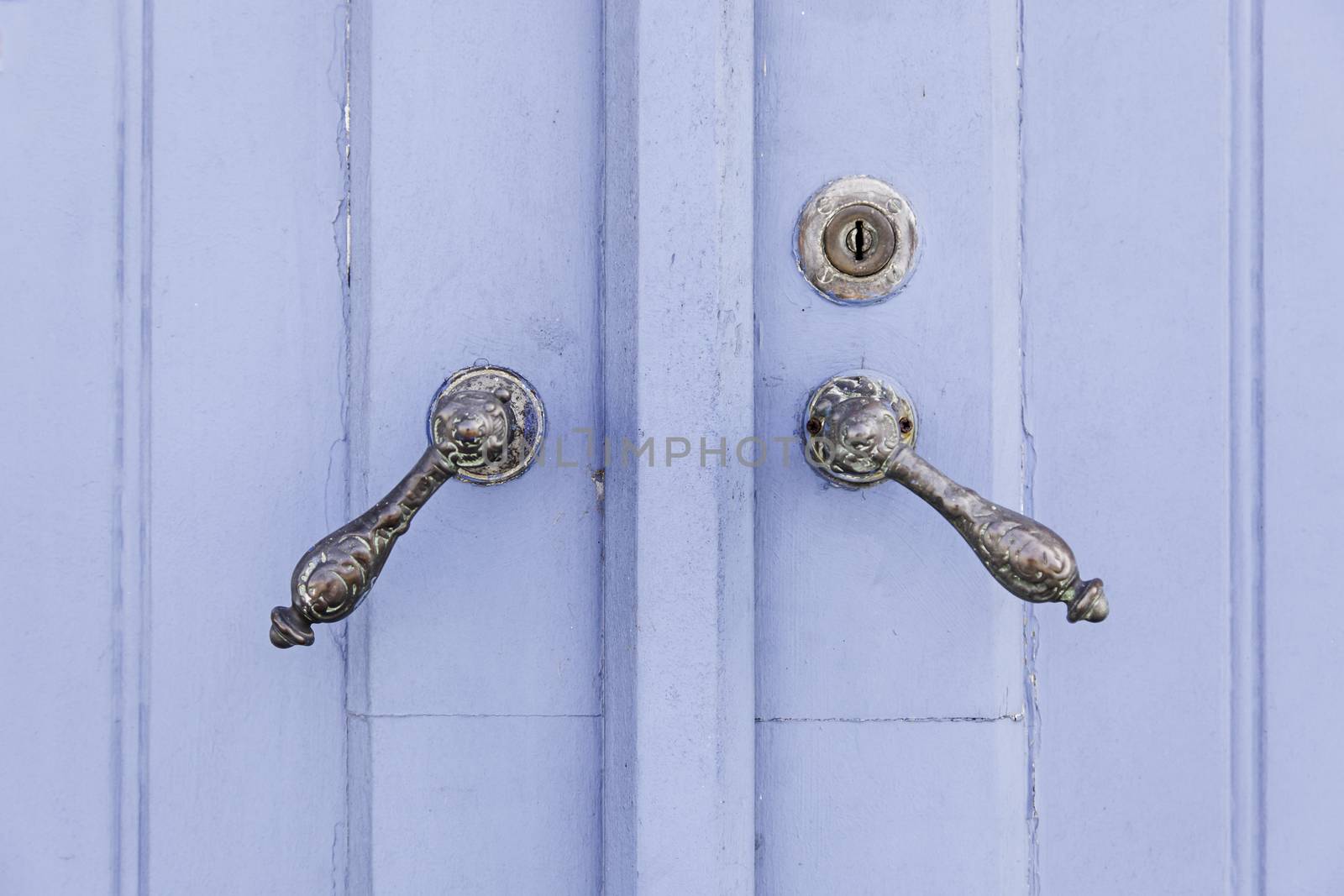 Old decorated door in blue, detail of urban decoration, protection