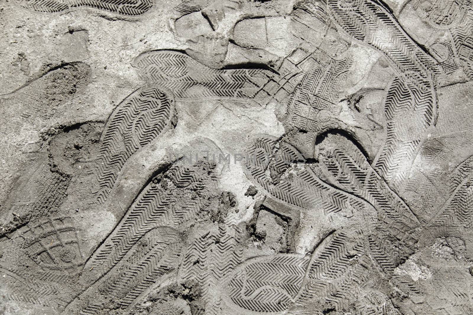 Footprints in the mud, detail of a shoe brands