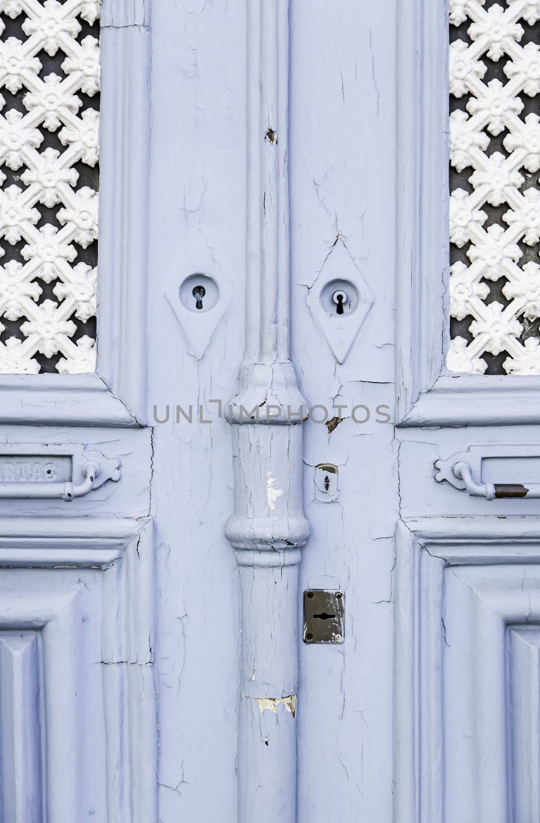 Old decorated door in blue, detail of urban decoration, protection