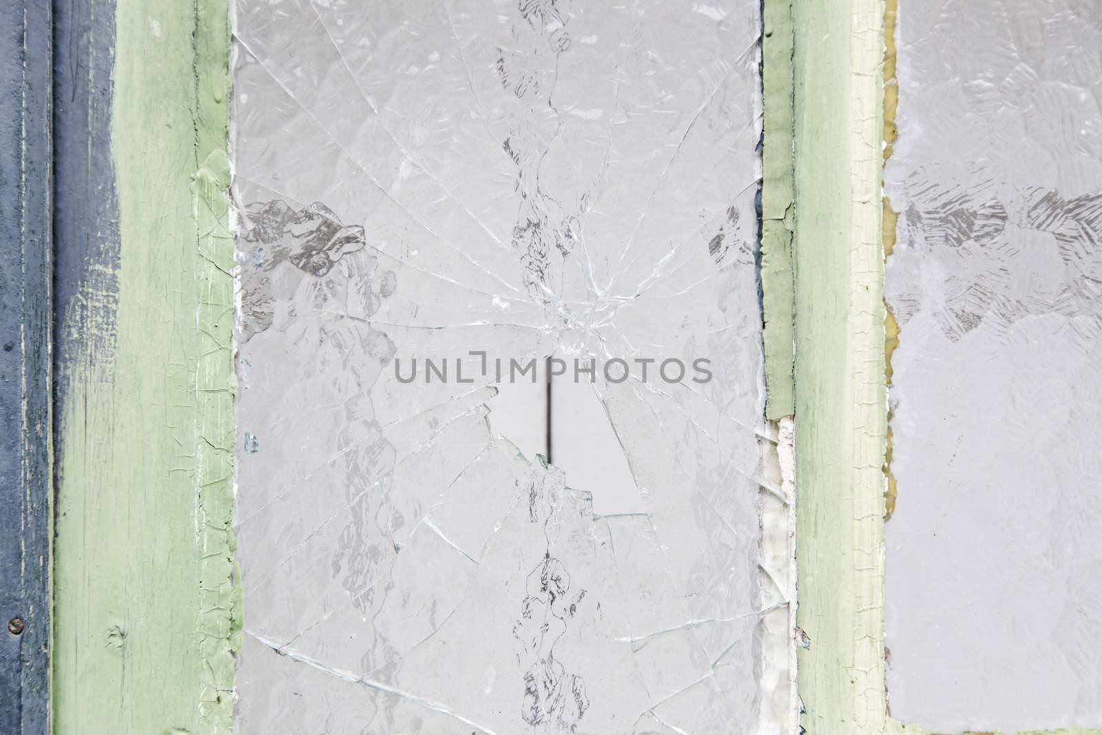 Broken glass window in urban building, vandalism