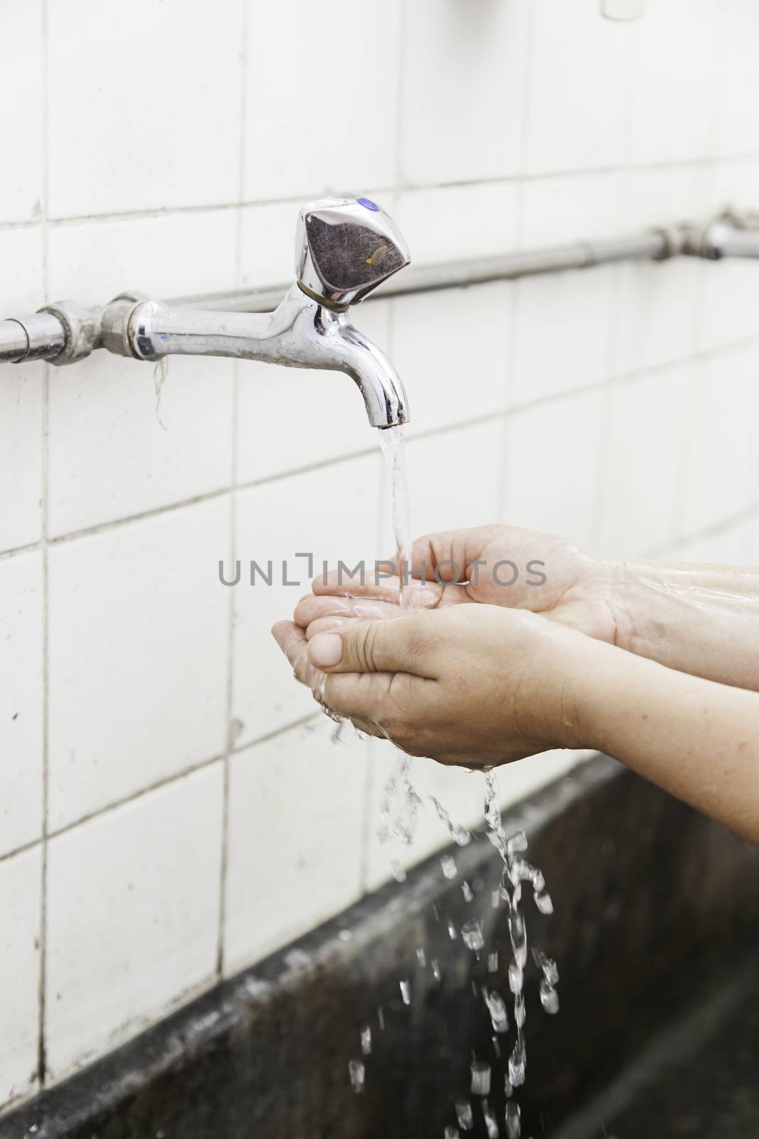 Washing hands in a sink, hygiene and cleaning