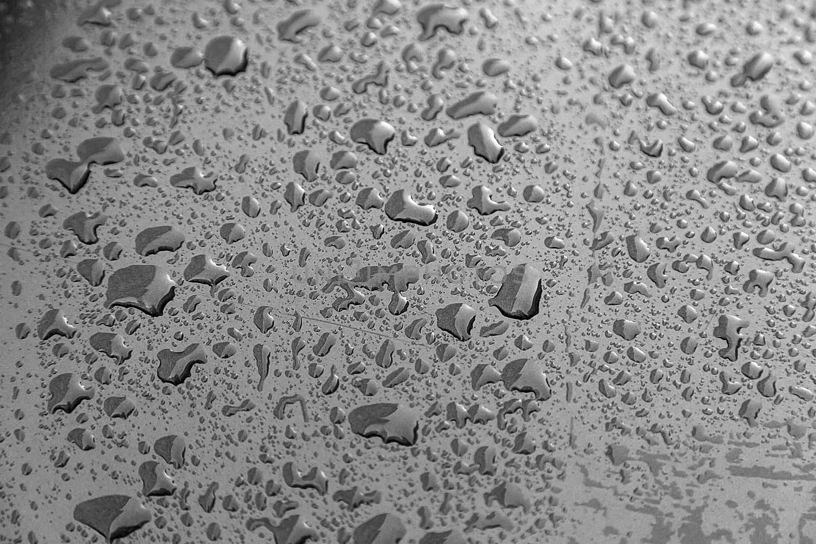 Rain drops, detail of a wet blue background, cold and texture