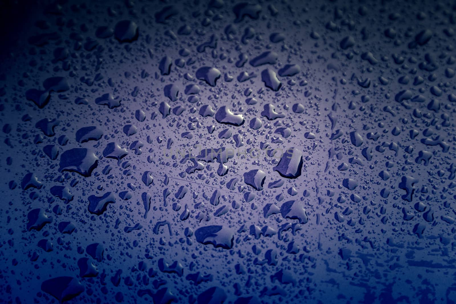 Rain drops, detail of a wet blue background, cold and texture