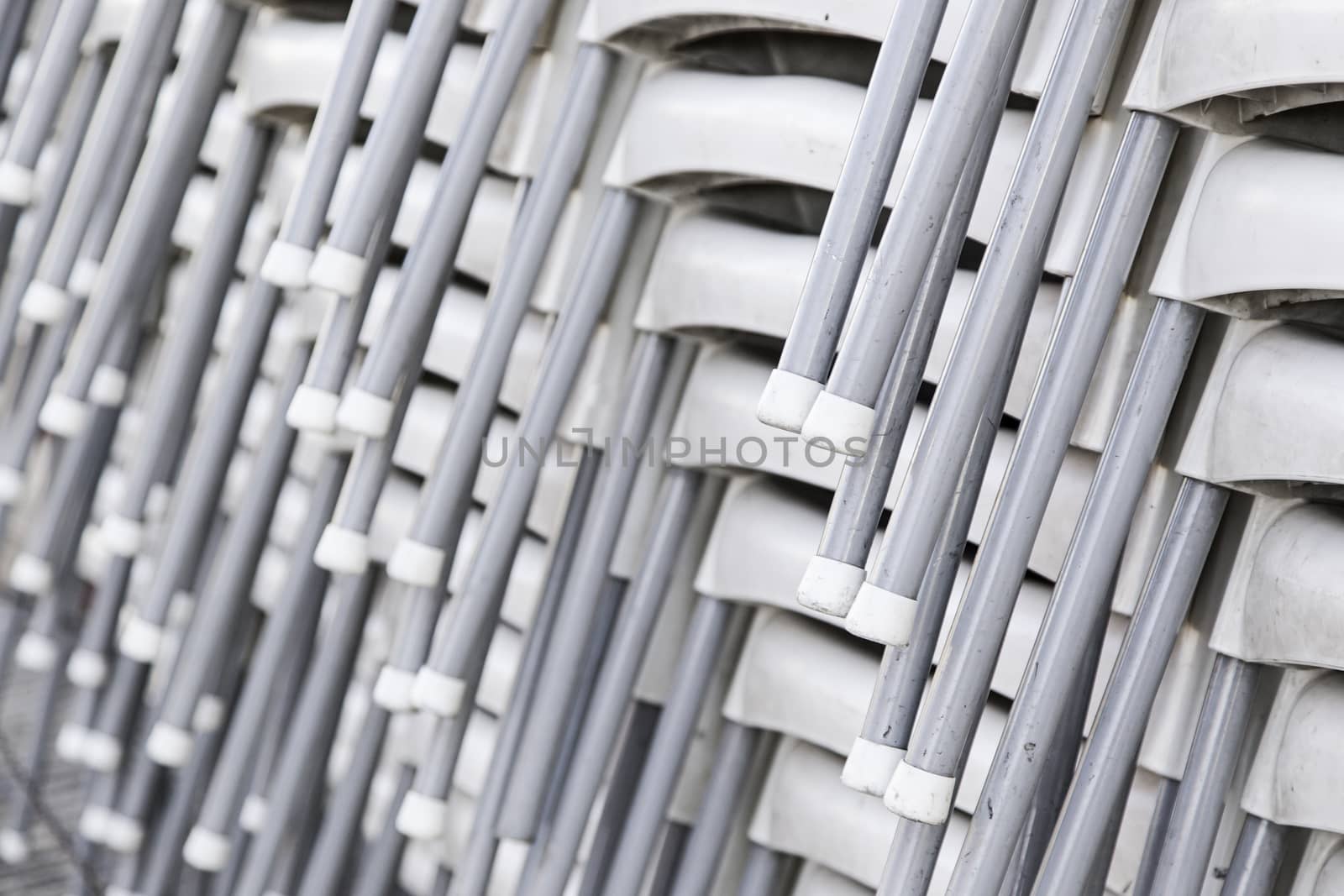 Chairs stacked in the street, detail of a warehouse