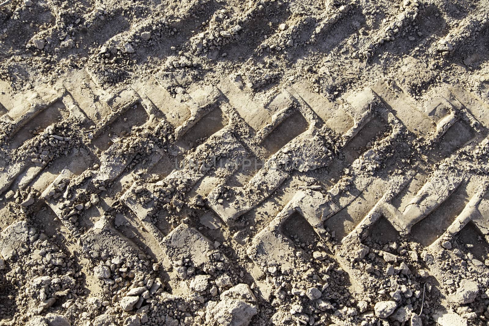 Traces of wheels in the mud, detail of marks in the nature