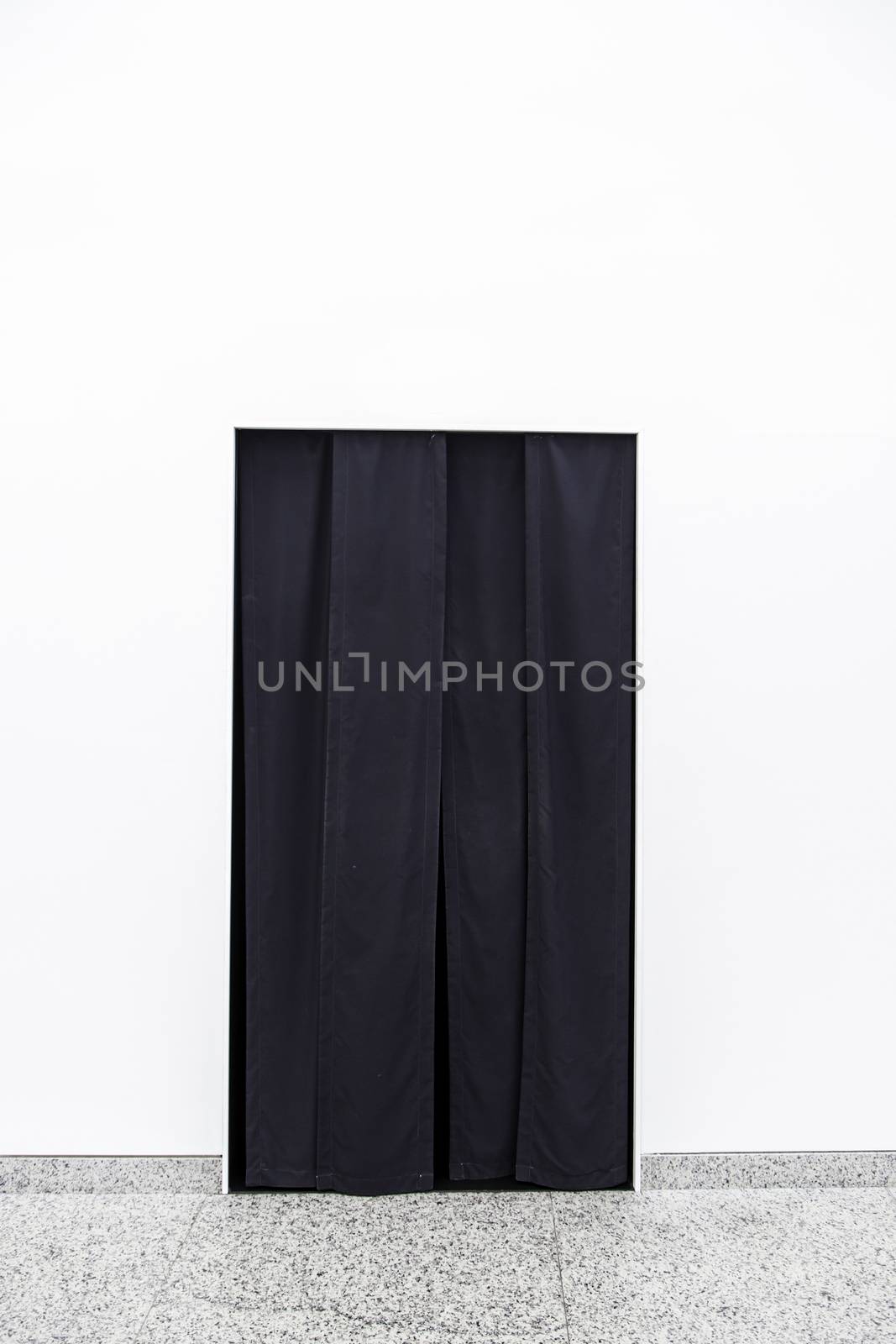 Black curtain on a door, detail of a curtain to separate rooms