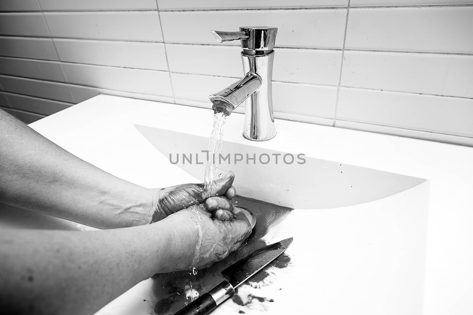 Assassin cleaning the blood, detail of a homicide, blood and death