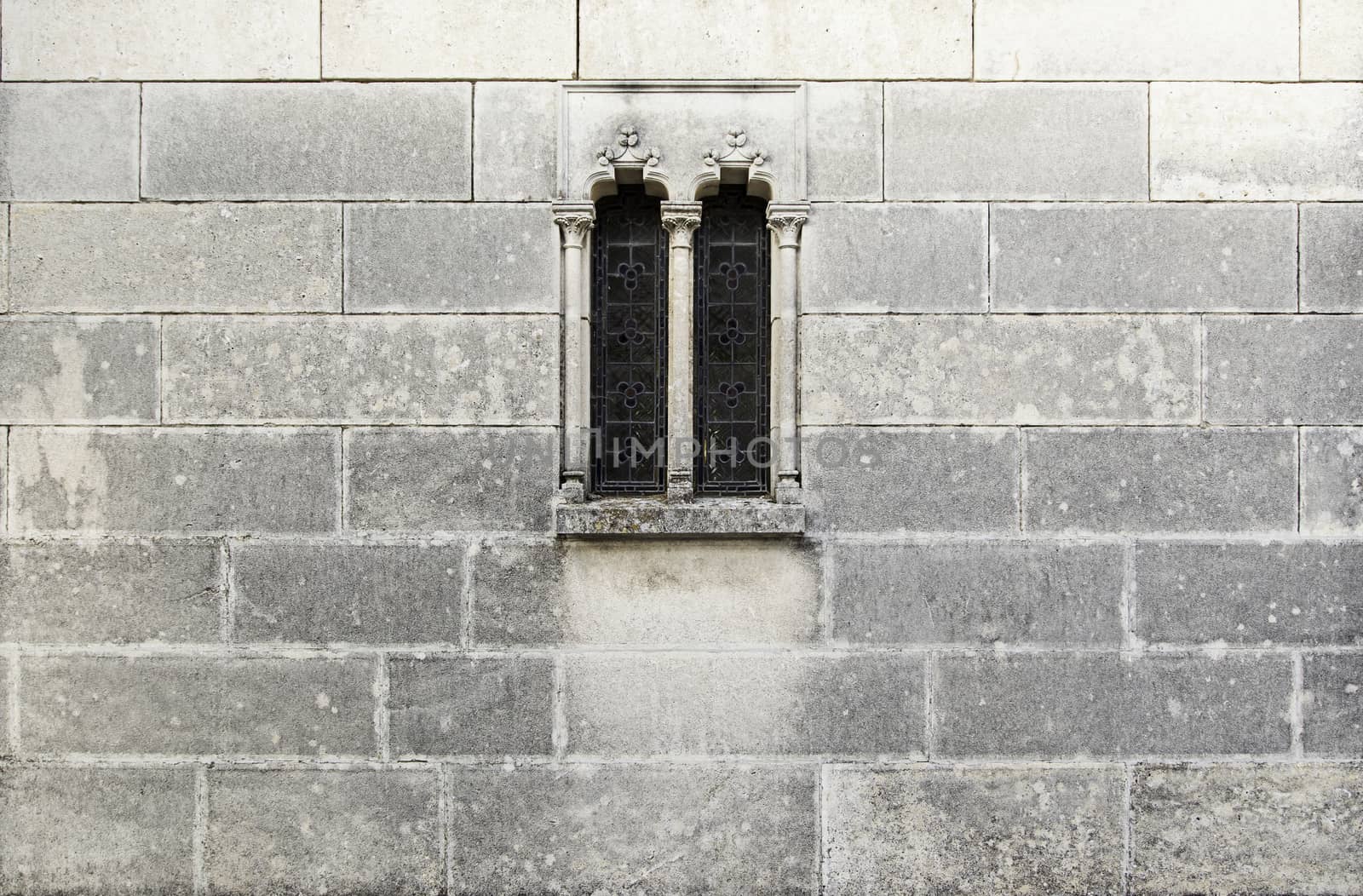 Medieval stone window, detail of a stone wall