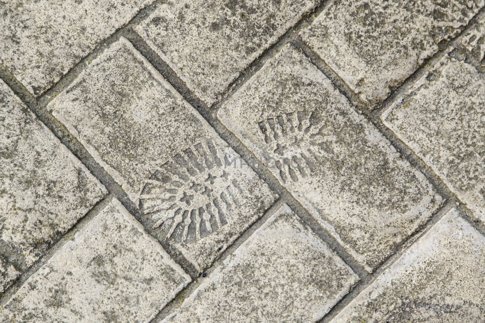 Footprint cement, detail of a sneaker mark, sign