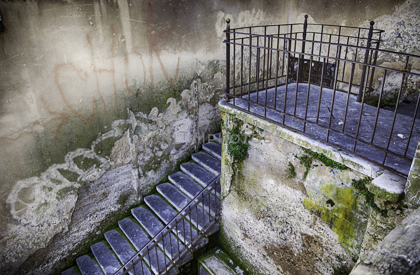 Old stone stairs, detail of a pedestrian stairs in the city, dirt and neglect