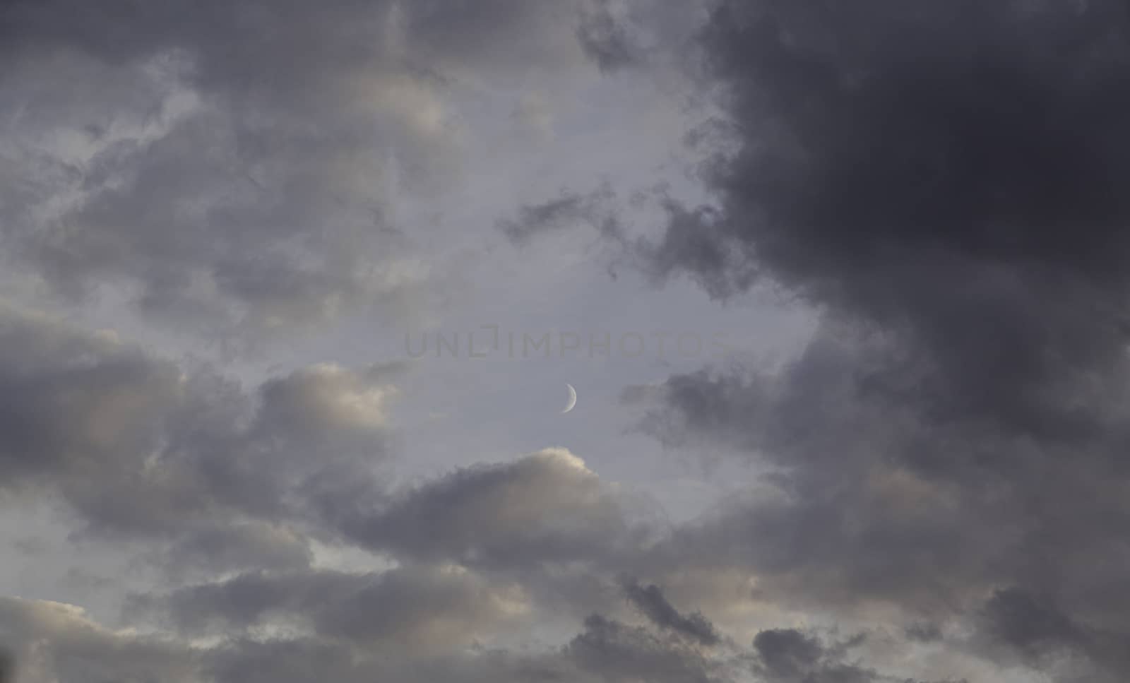 Cloudy sky with moon, detail of a rainy day, moon at night