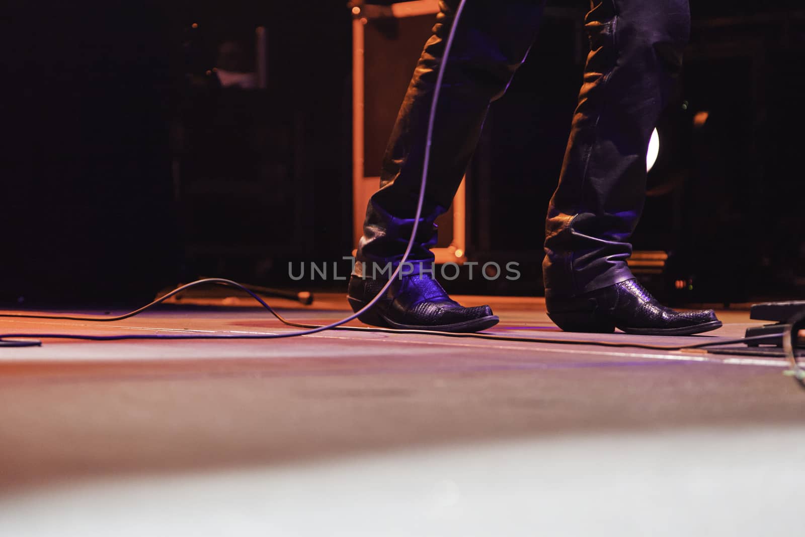 Feet of a singer at a concert, detail of a rock concert, party and music