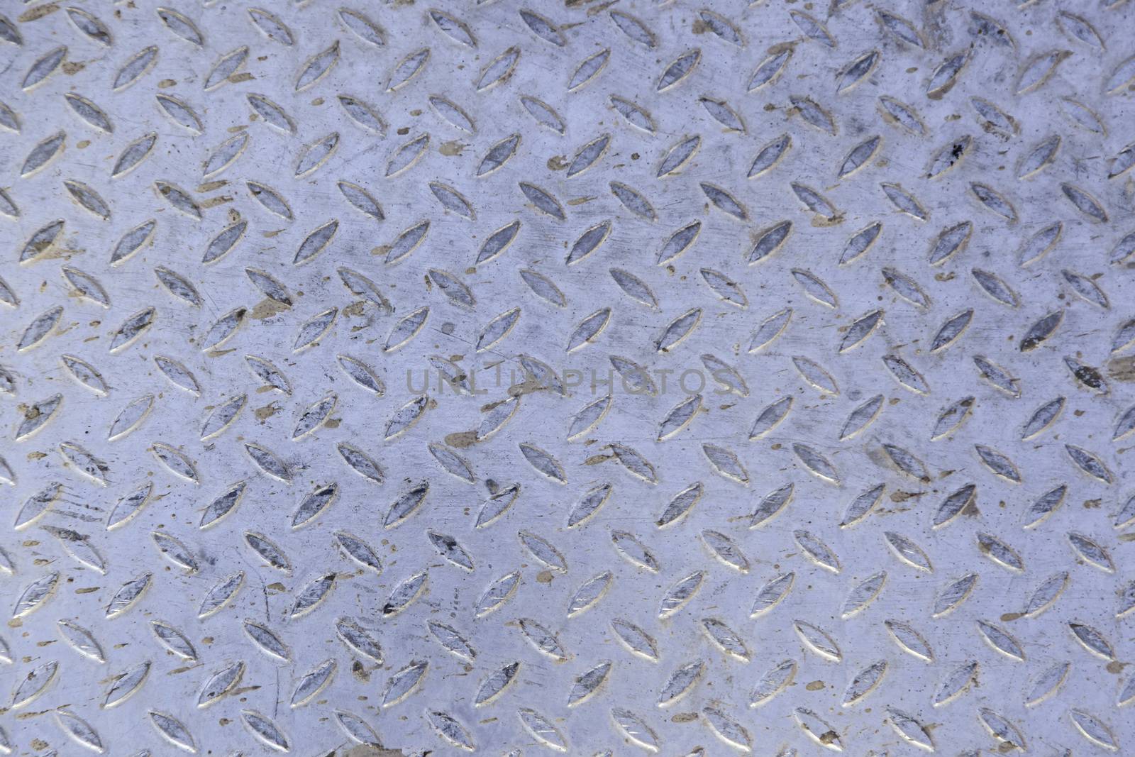 Rough metal background, detail of a non-slip metal, textured background, dirty and damaged metal
