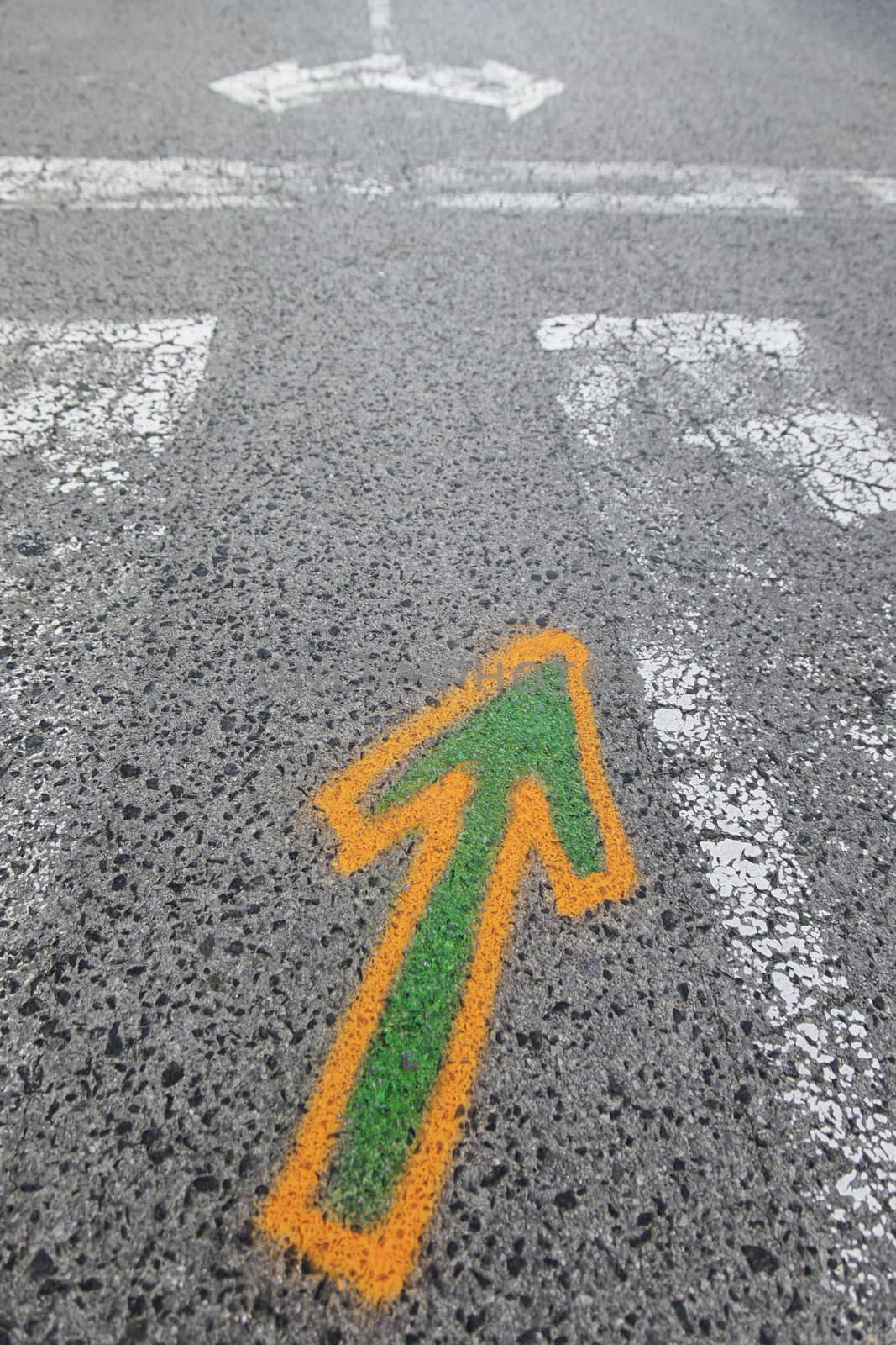 Arrow painted on the asphalt, detail of information and indication, road safety