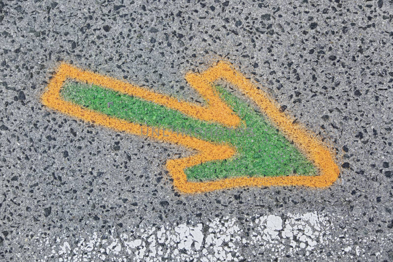 Arrow painted on the asphalt, detail of information and indication, road safety