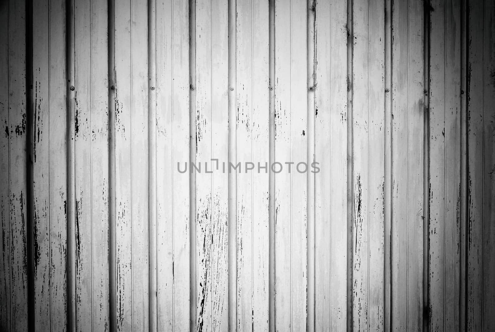 Metal door painted white, detail of a rusty gate and damaged