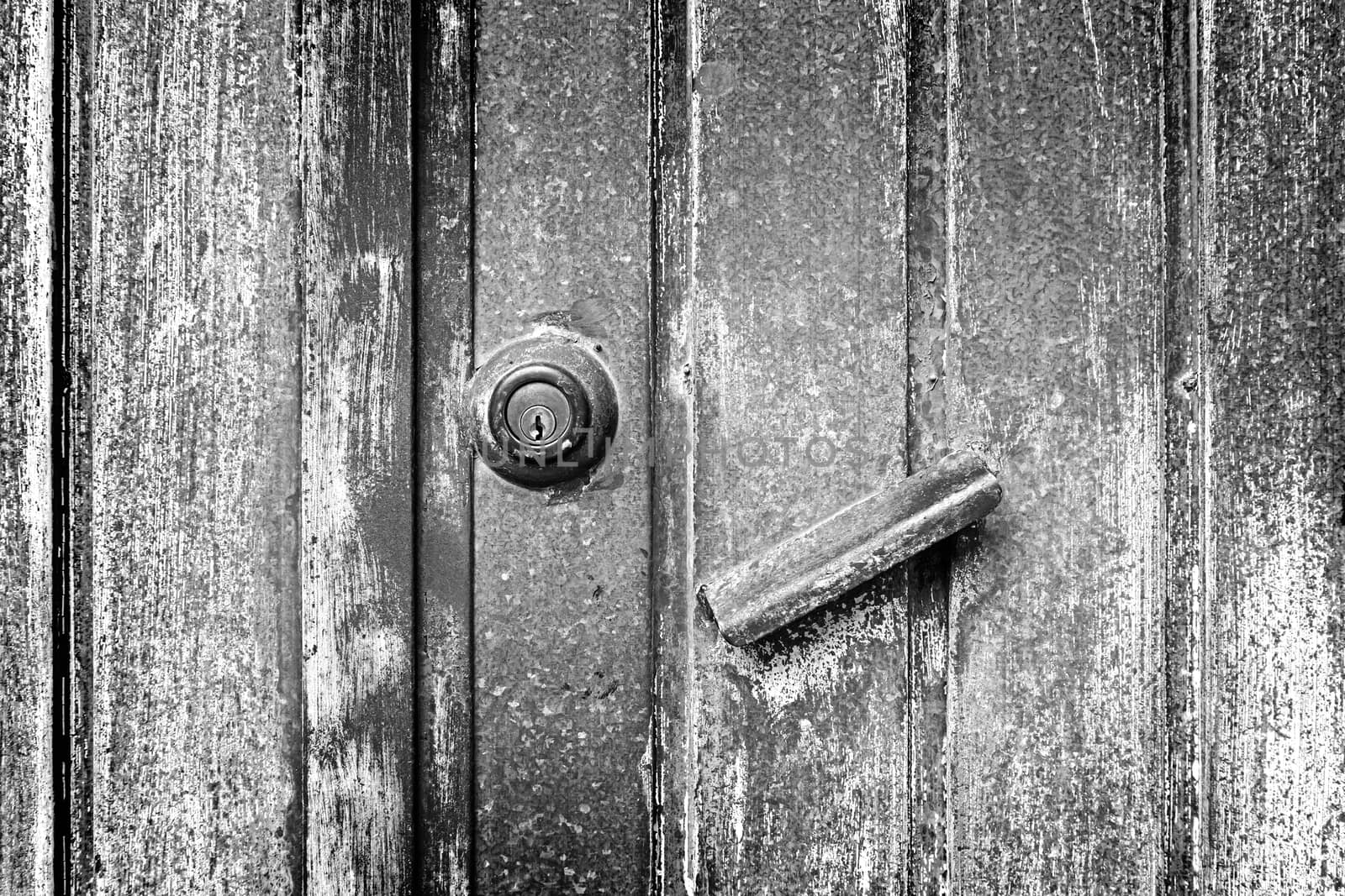 Abandoned rusty metal door detail of an old door, protection