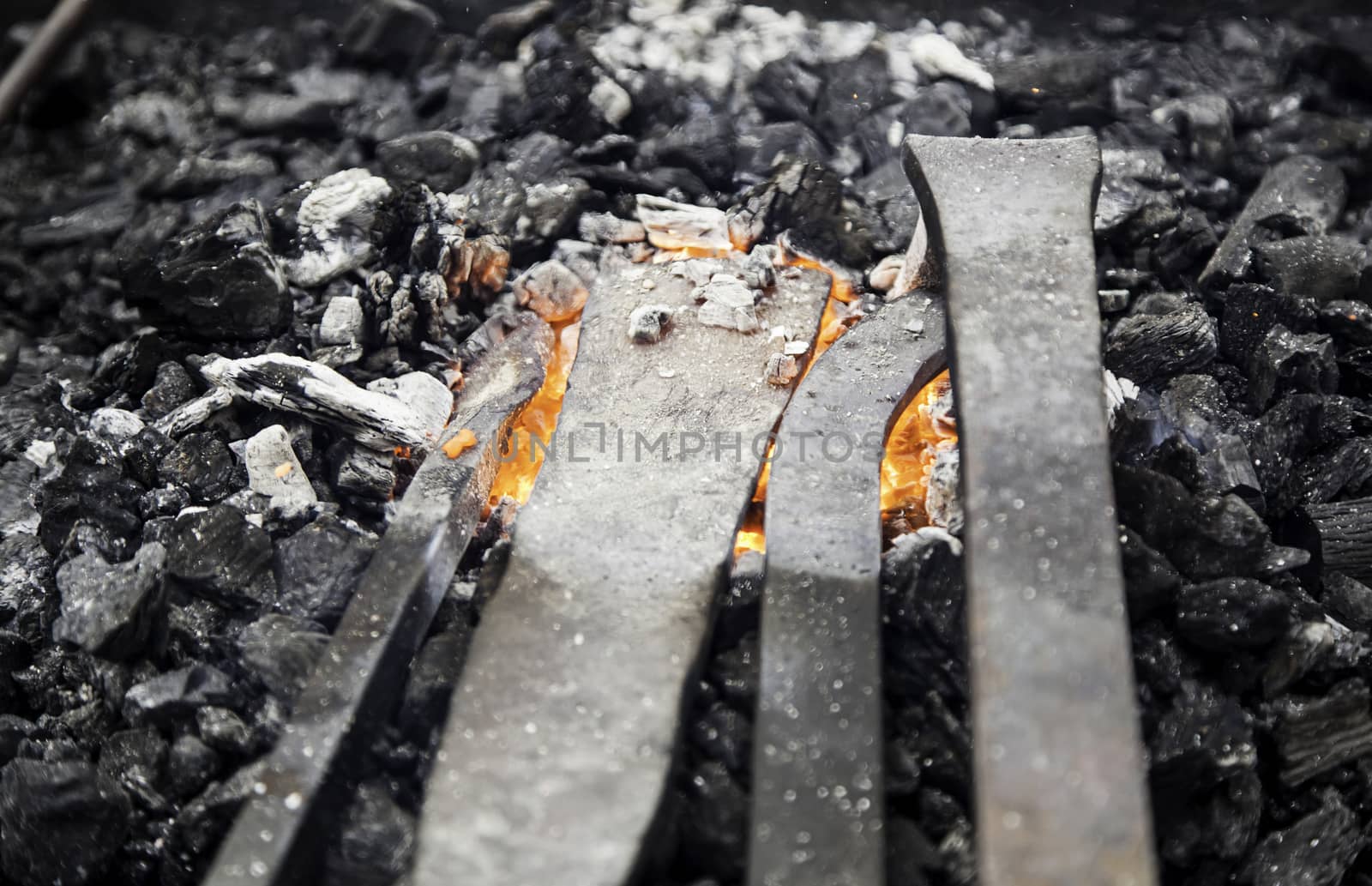 Embers in a forge, detail of an old iron forge, molding iron