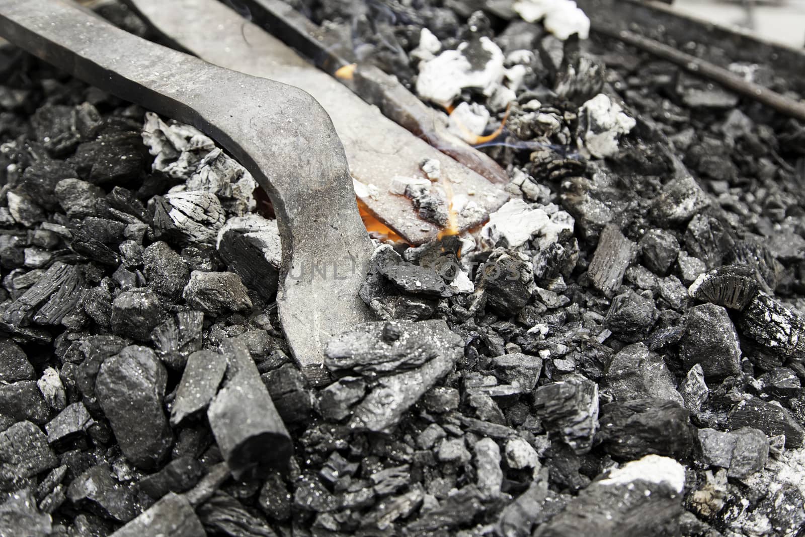 Embers in a forge, detail of an old iron forge, molding iron