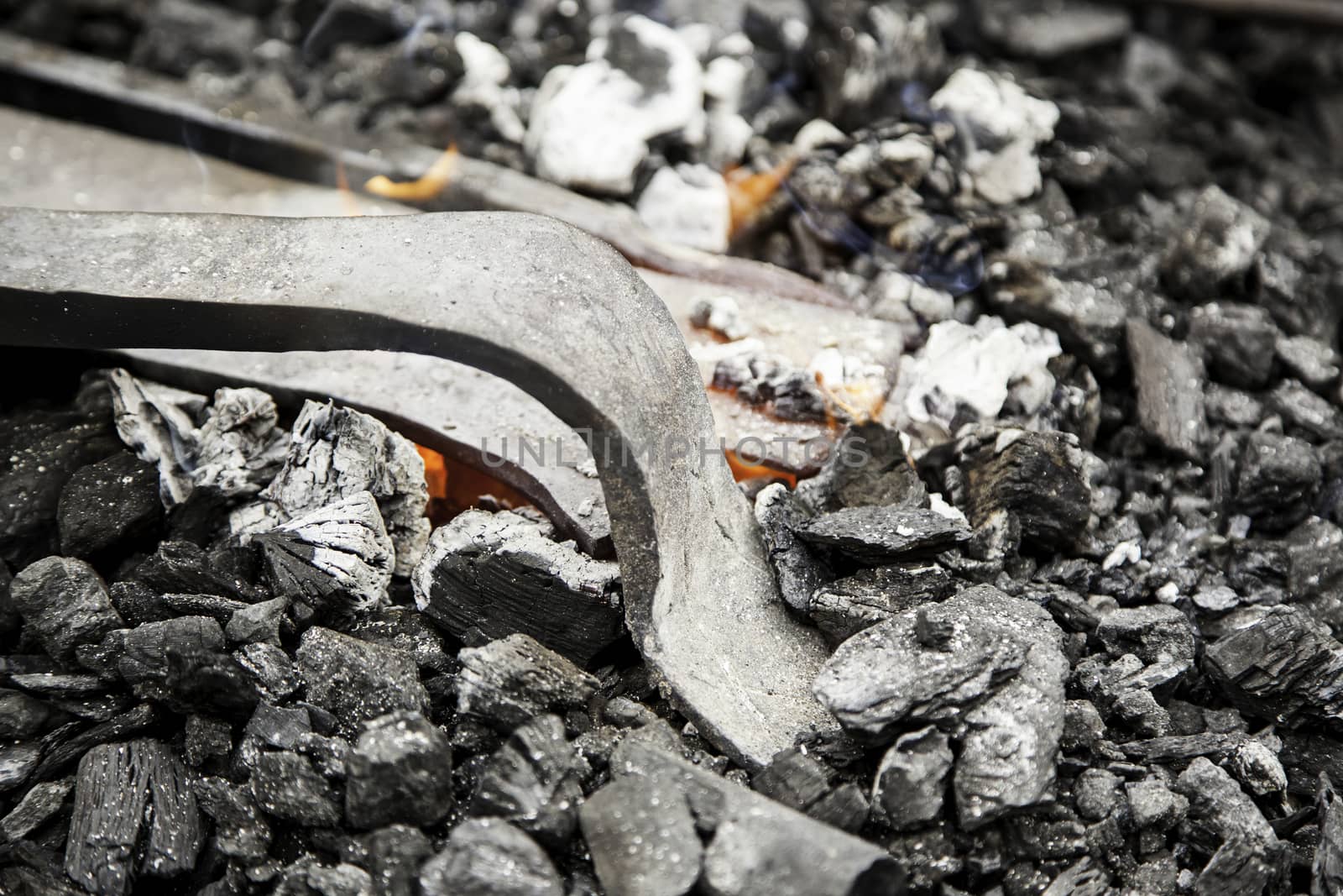 Embers in a forge, detail of an old iron forge, molding iron