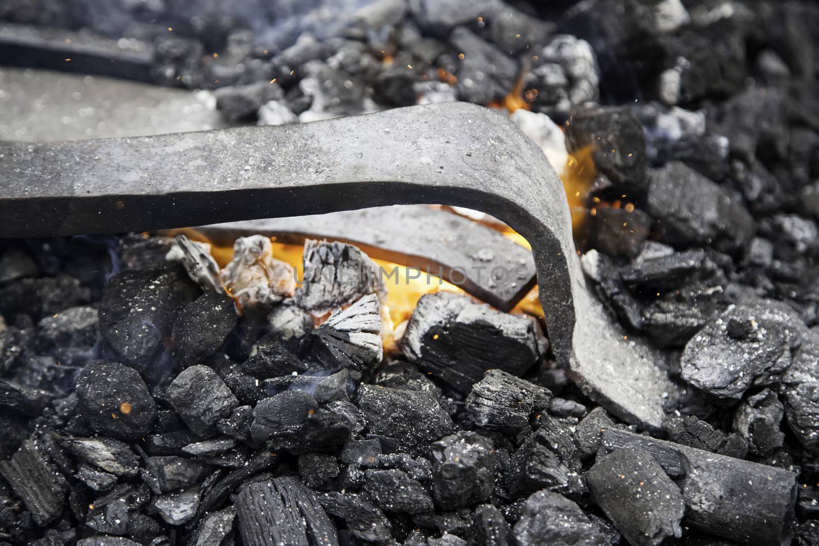 Embers in a forge, detail of an old iron forge, molding iron