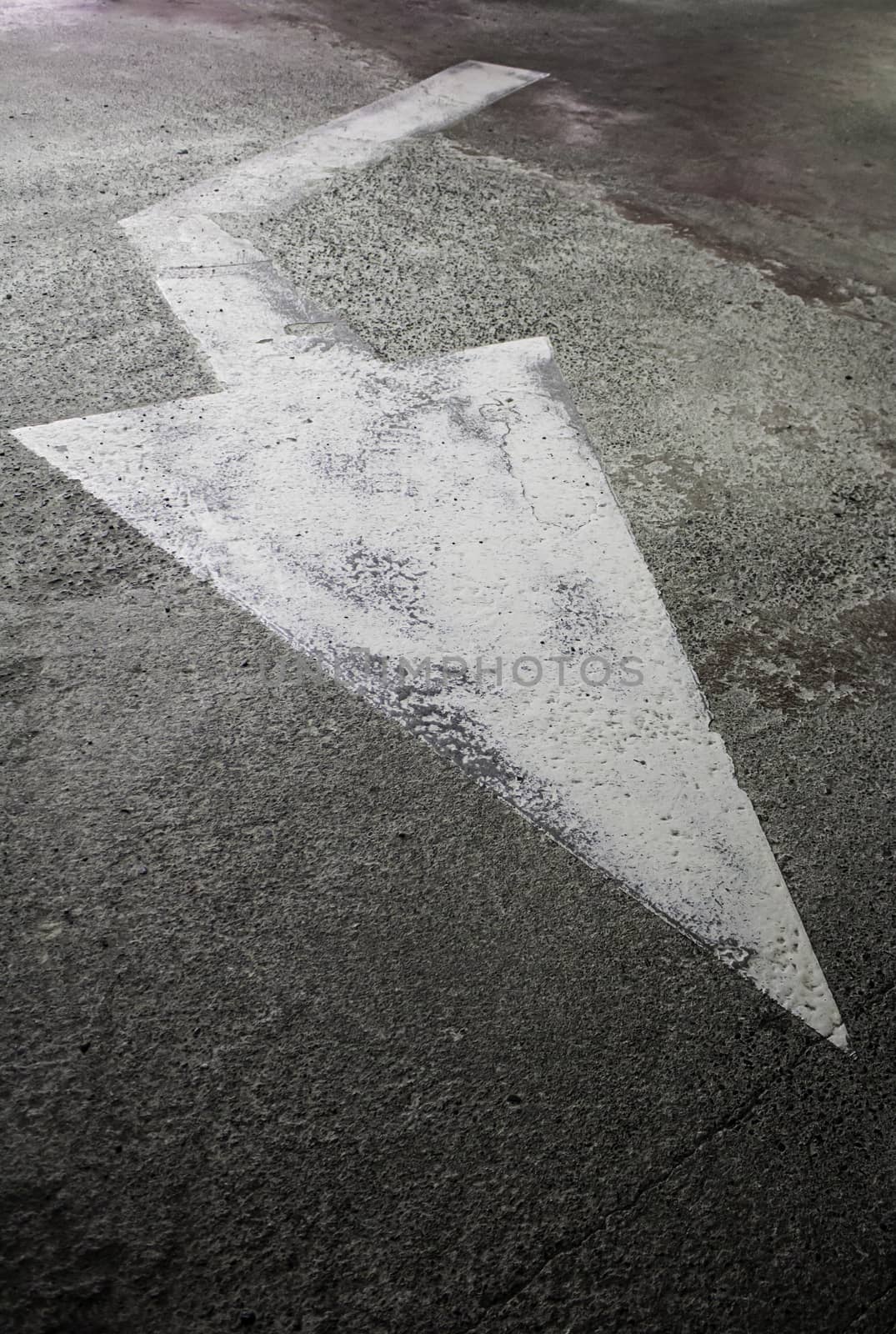 Arrow of indication on the road, detail of traffic signal, traffic