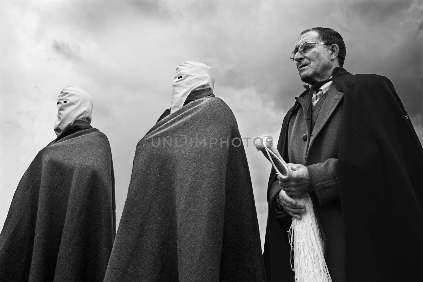 SAN VICENTE DE LA SONSIERRA, SPAIN - GOOD FRIDAY FRIDAY APRIL 6: Man does penance through self-flagellation during Easter holy procession on April 6, 2012, San Vicente de la Sonsierra, Spain. by esebene