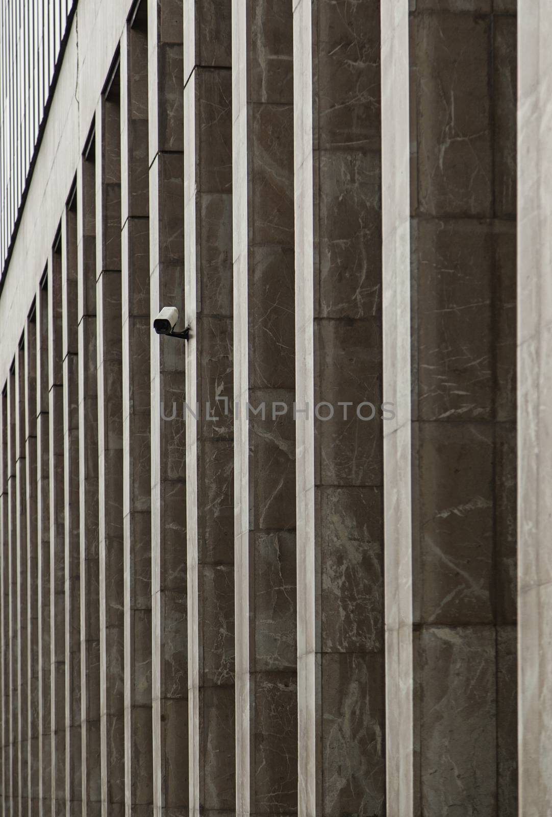 Surveillance camera in columns, detail of a facade in the city, security and precaution, closed circuit