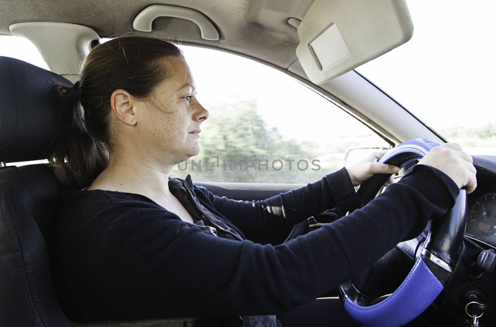 Young woman driving, detail of a modern woman, transportation and fun, speed