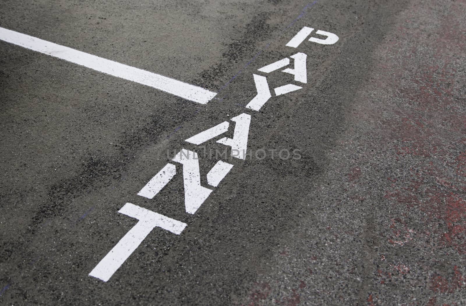 Sign of payment on the asphalt, detail of sign of imformation