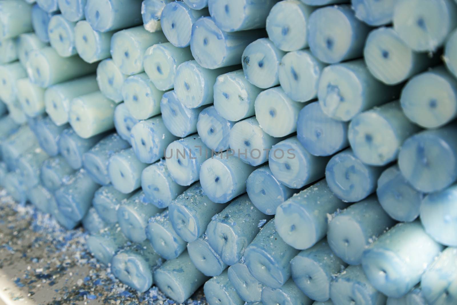 Blue candles, candle wax detail, artificial lighting