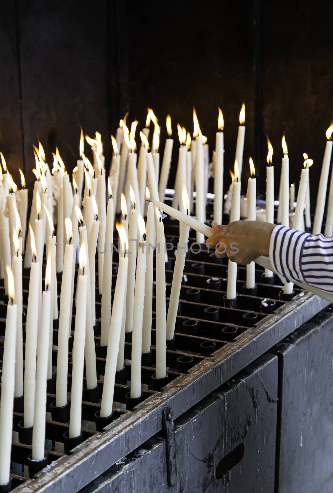 Candles lit, detail of old lighting element
