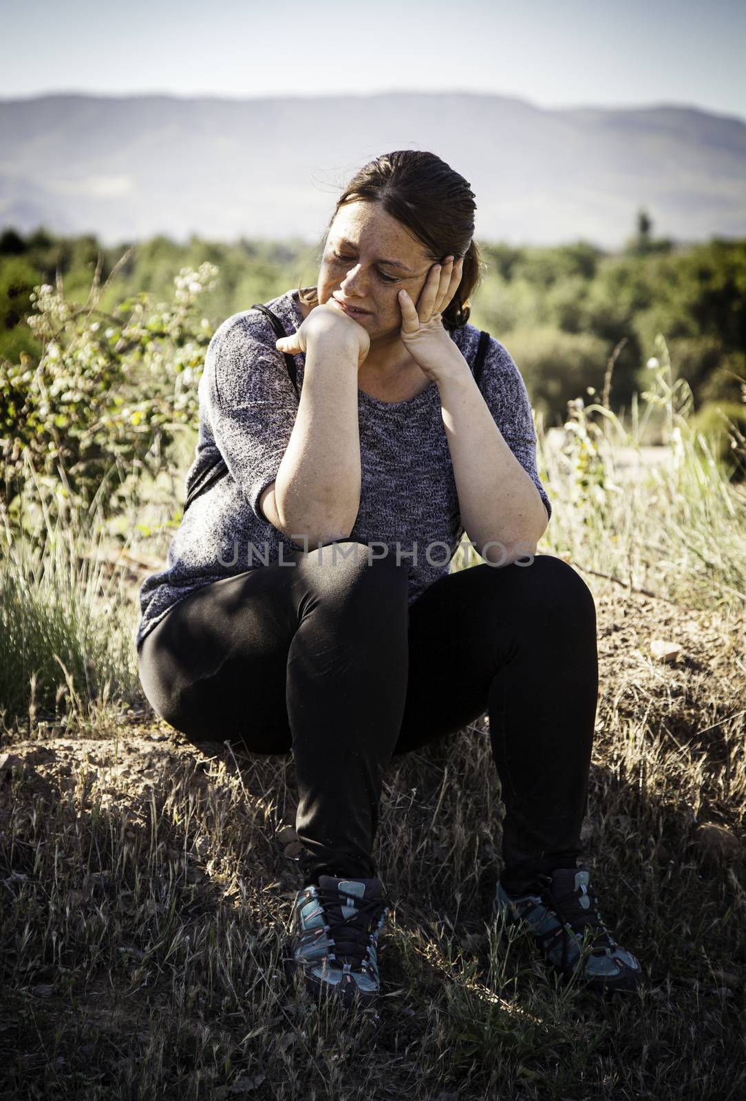 Pensive woman, detail of a melancholy woman in nature
