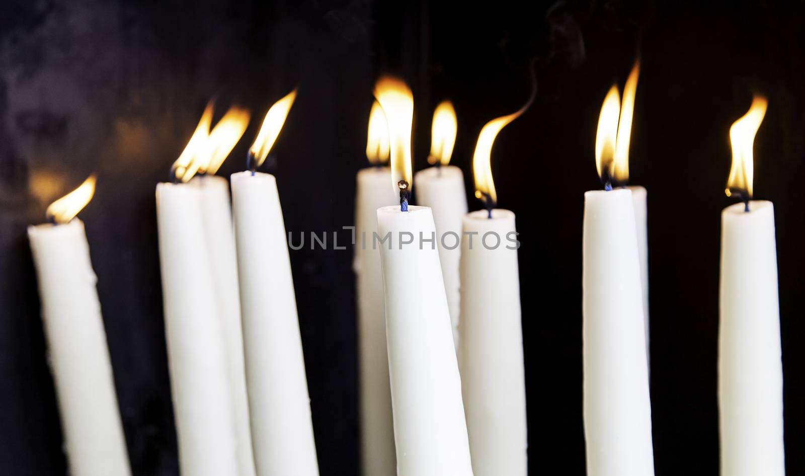 Candles lit, detail of old lighting element