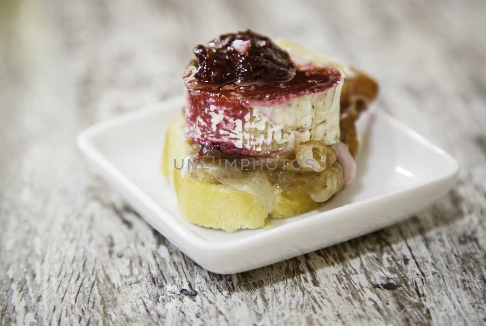 Goat cheese and raspberry, gourmet appetizer detail, haute cuisine