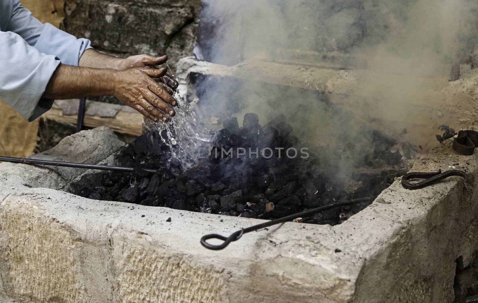 Extinguishing flames with water in the carbon, safety detail