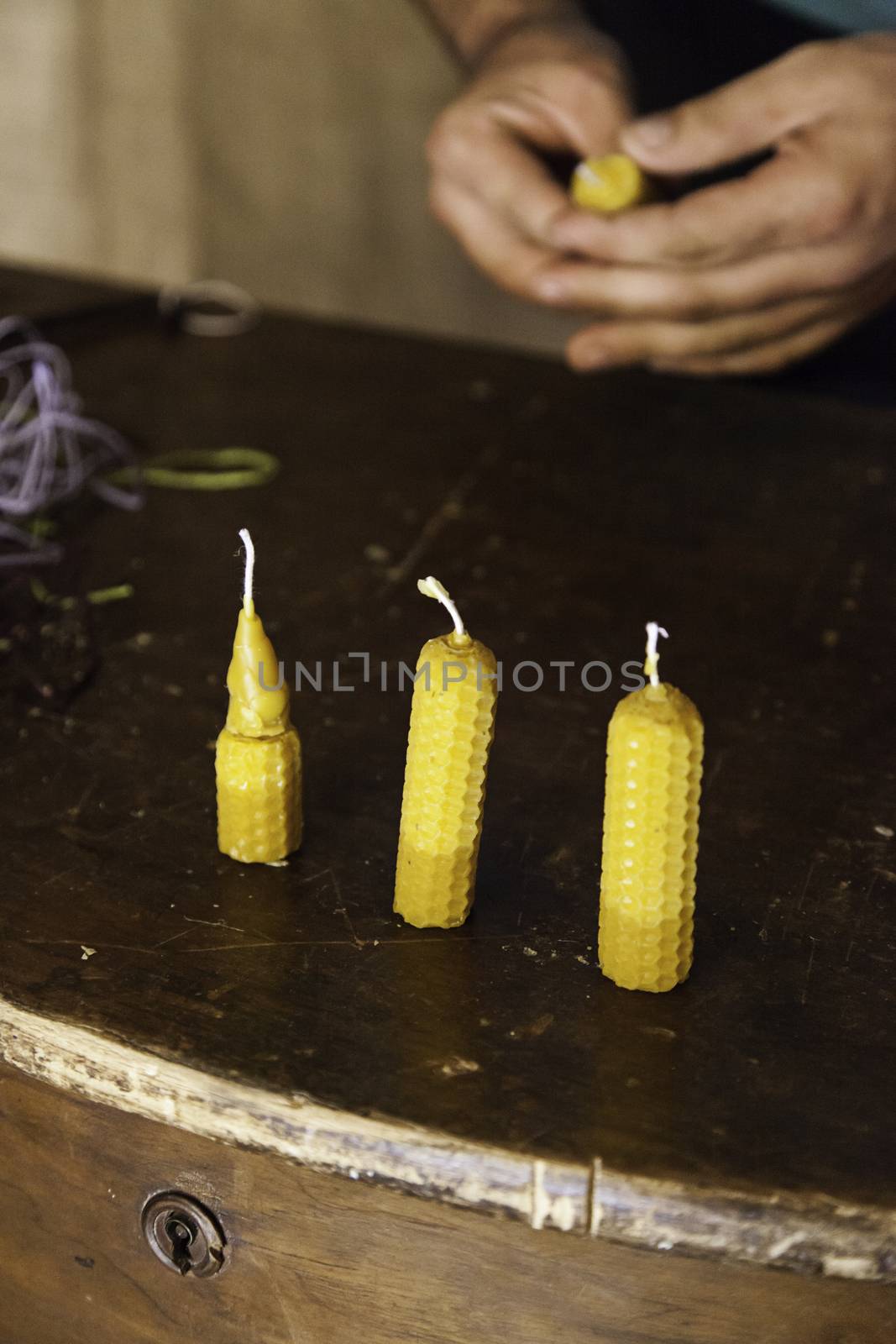 Artisan expert making beeswax candles, detail of old craft