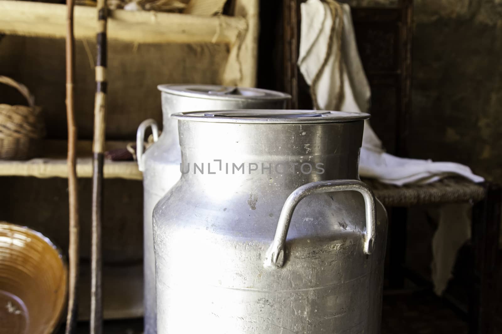 Antique metal containers for milk, detail of objects on a farm