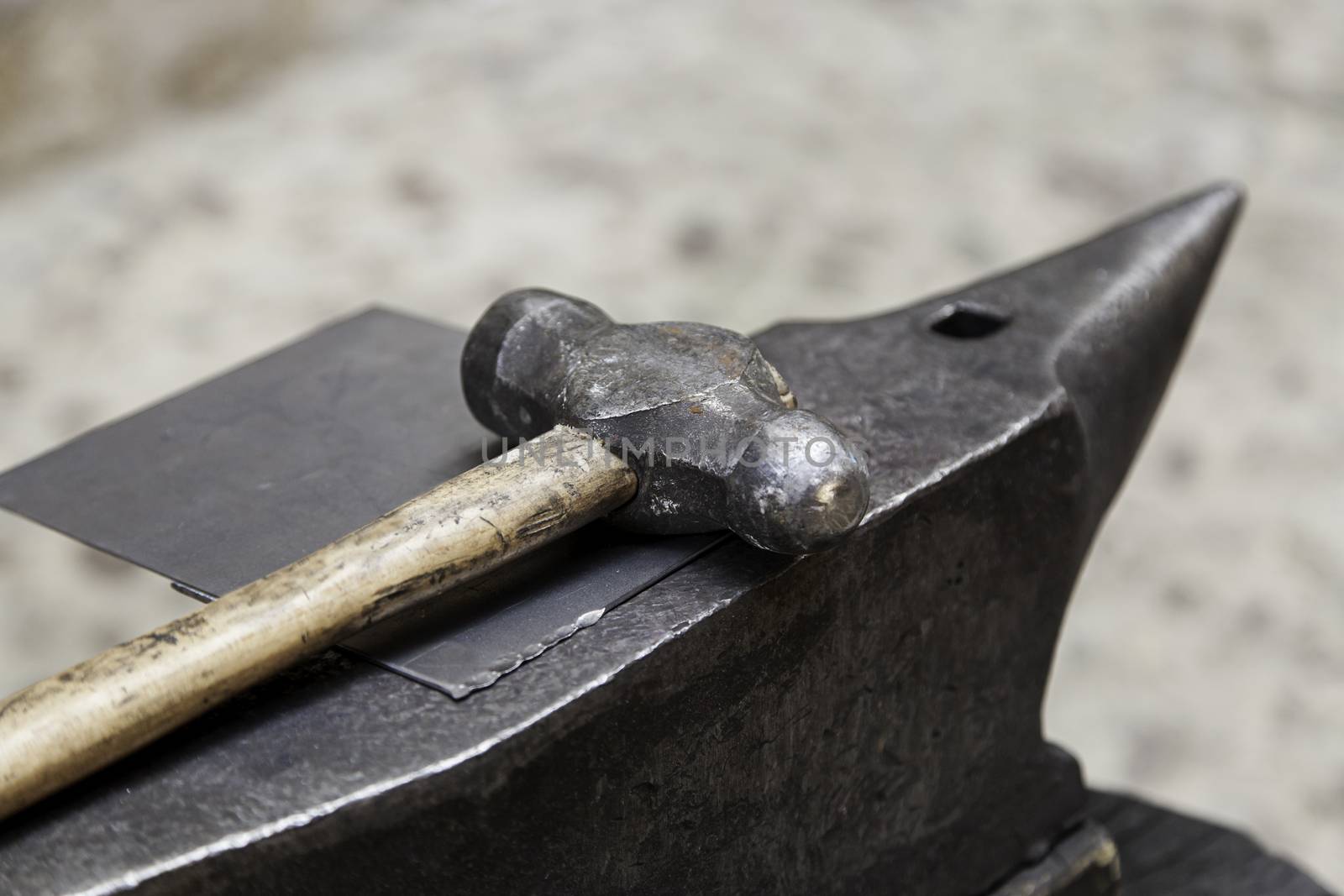 Old hammer and anvil on a forge, detail of old tool