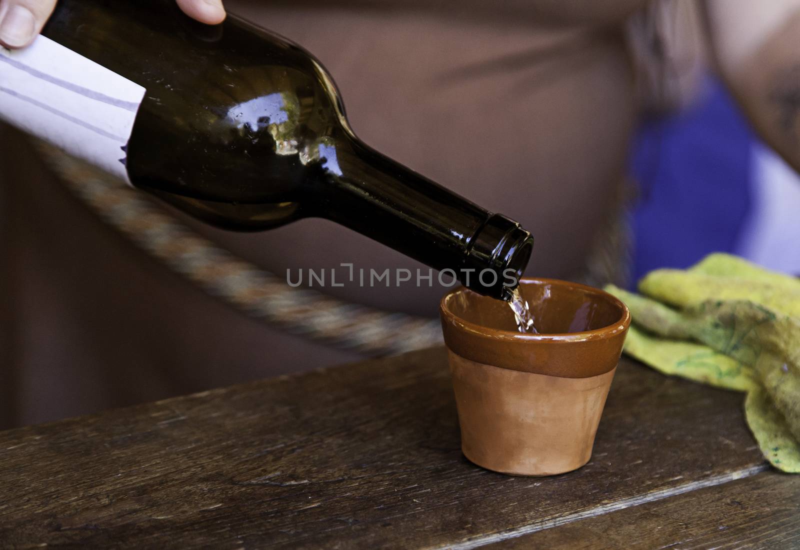 Serving wine in a clay cup, detail of a bar, alcohol and beverage service