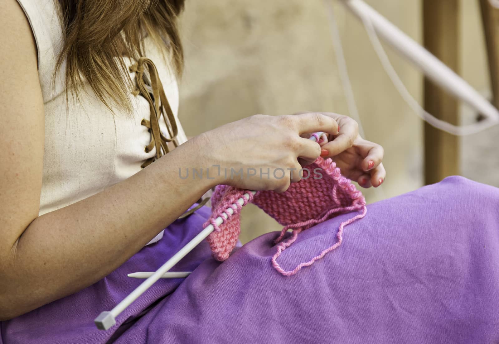 Young woman knitting clothes wool, detail of old tradition to make clothes