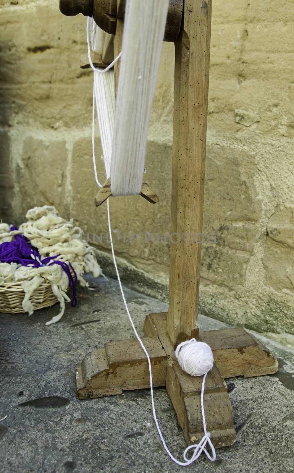 Old spinning wheel to work with wool, detail of old wooden machinery