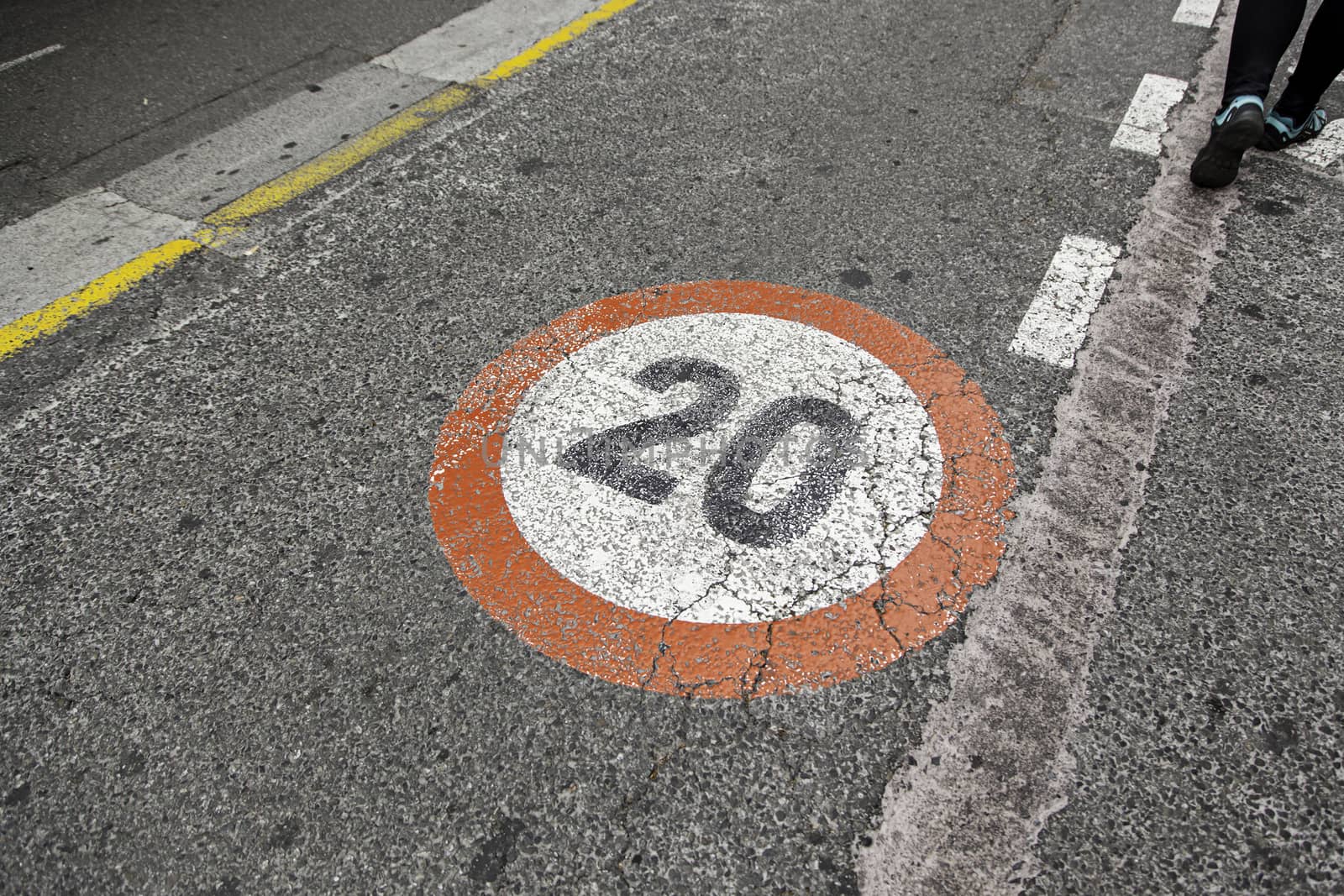 Speed limit sign on asphalt, detail of obligation