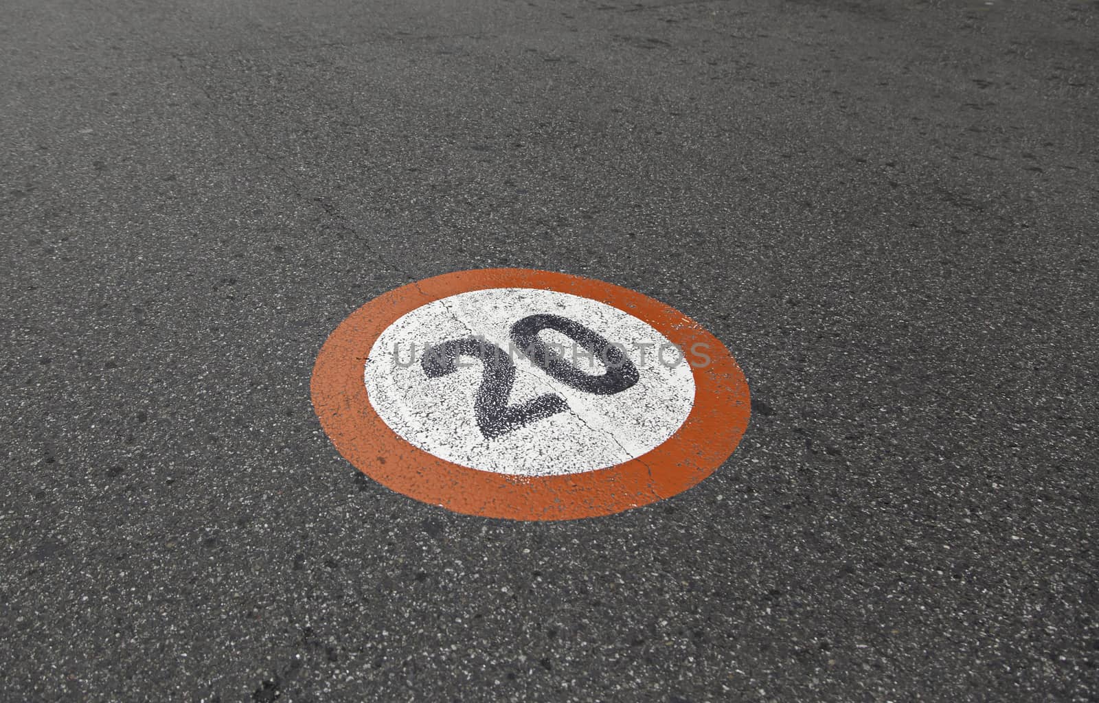 Speed limit sign on asphalt, detail of obligation