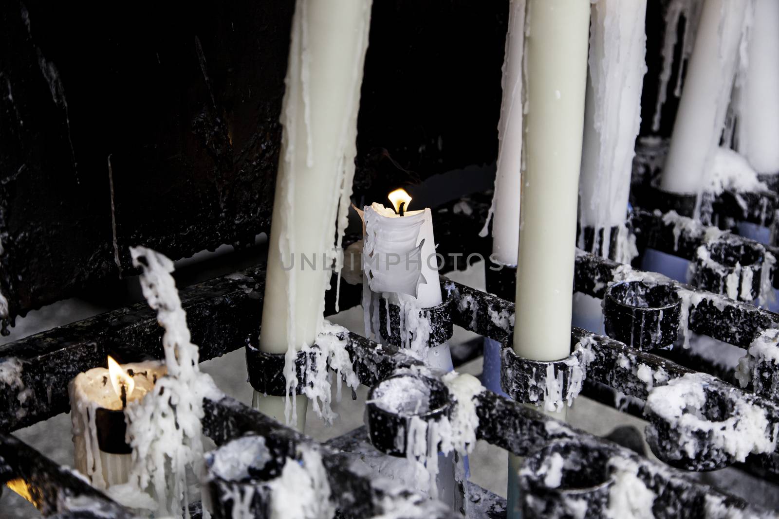 Wax candles burning in a Christian tradition, flame and faith