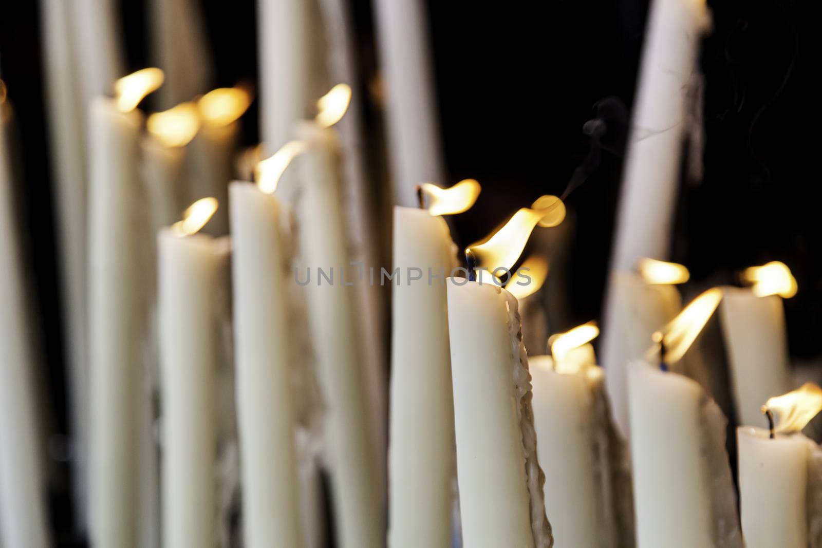 Wax candles burning in a Christian tradition, flame and faith
